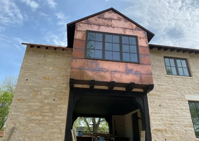 Copper metal panel facade on a stone building for Roof Repair in Cape Elizabeth