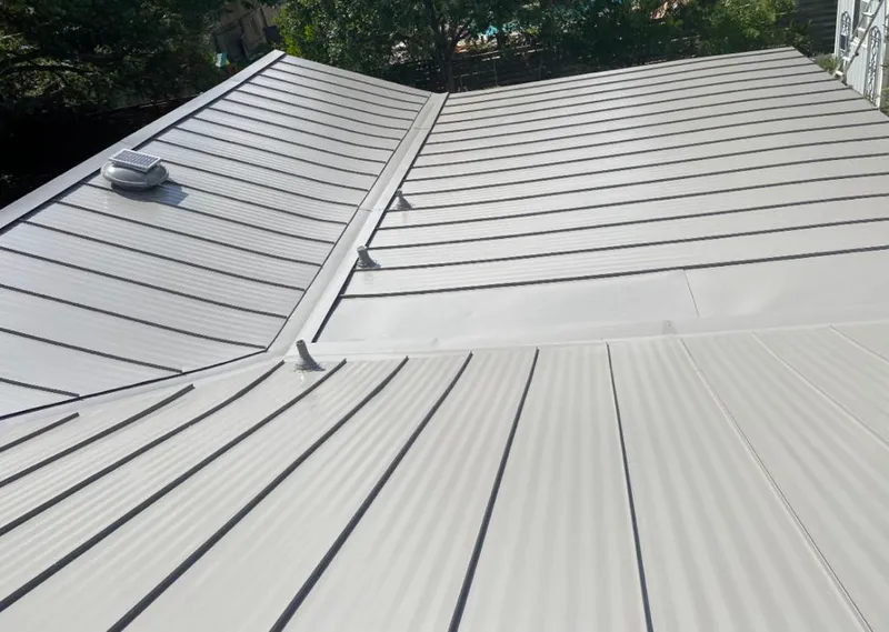 Solar attic fan installed on a metal roof for Roof Ventilation in Cape Elizabeth